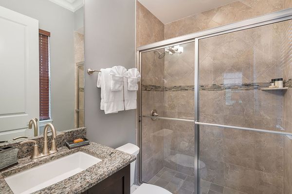 The master en-suite bathroom features a glass door walk-in shower