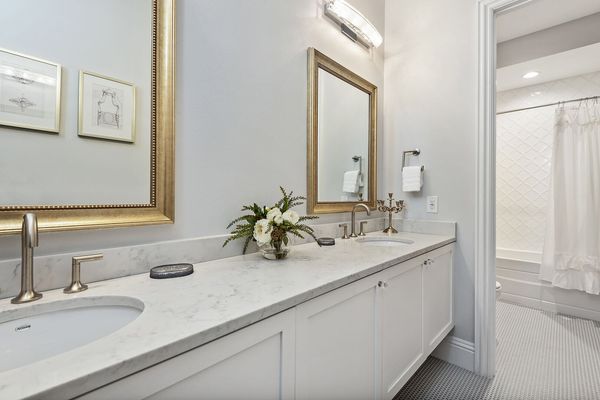 The connected bathroom has a dual vanity