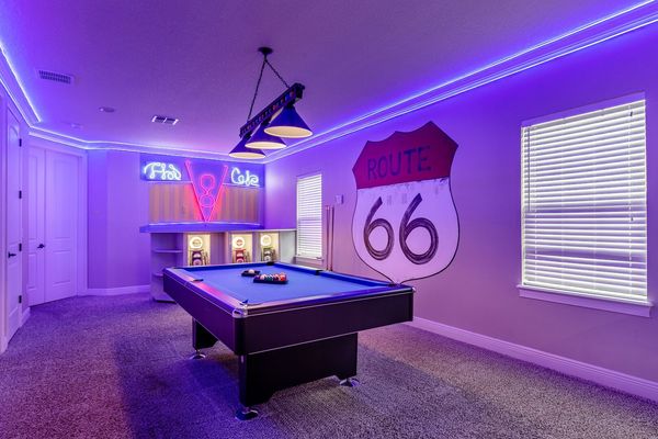 The room features a fun Cars theme complete with custom artwork and a pool table