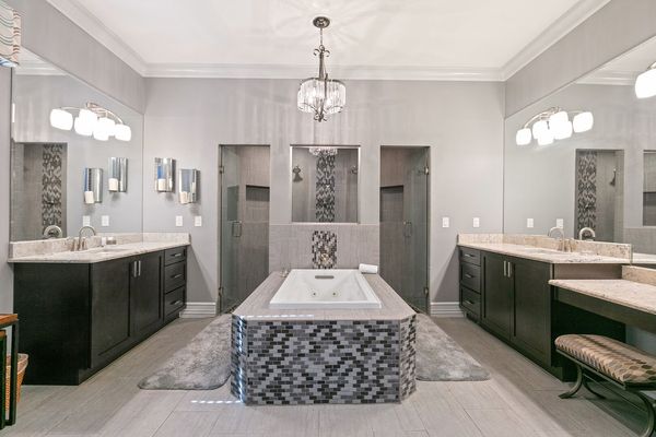 The master en-suite bathroom features a walk-in shower and jetted tub to relax