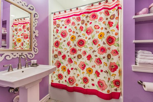 The en-suite bathroom has a tub/shower combination