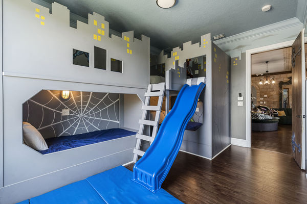 Superheroes can slide all day in their bedroom with two full beds and two twin beds