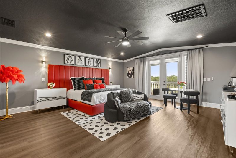 This luxurious master bedroom features a King bed and a private balcony