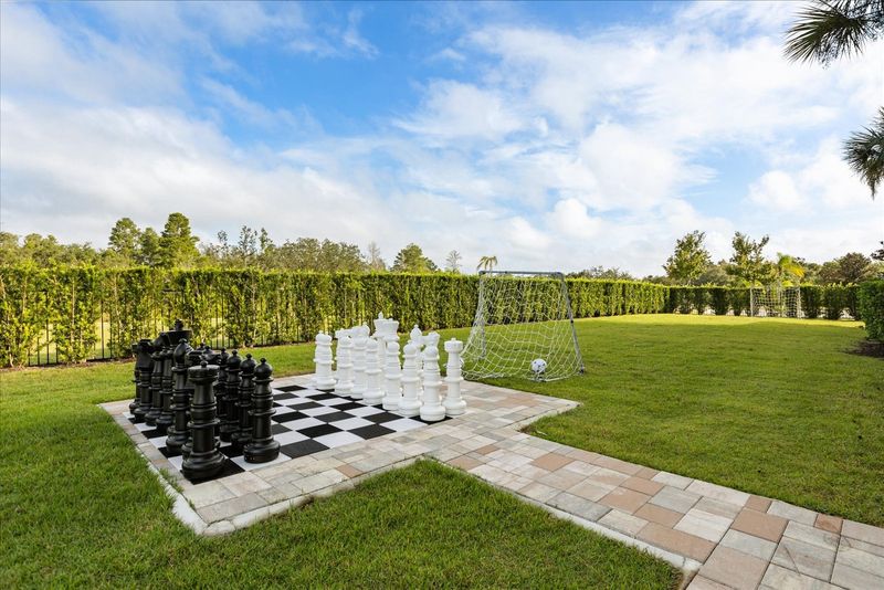The home features a beautiful green space to play games outdoors