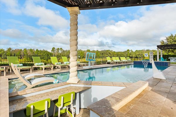 A custom built 60-foot private pool with spillover spa and sunken pool bar