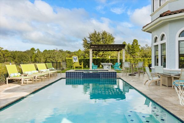 This beautiful custom pool with spillover spa overlooks the Jack Nicklaus Signature Golf Course