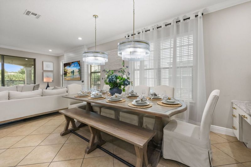 A gorgeous formal dining table has 6 seats and a bench for 4 for a total of 10 guests.