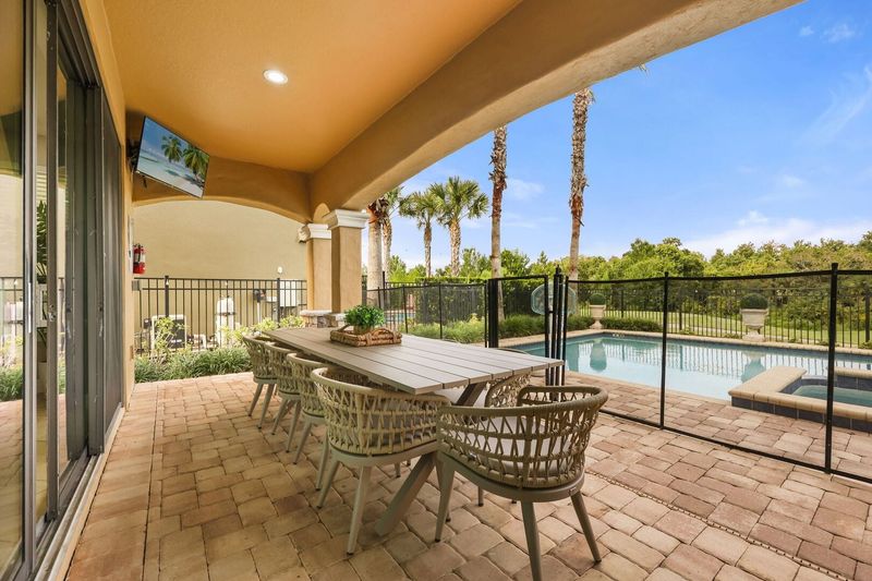An outdoor SMART TV and plenty of patio seating.