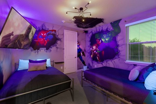The room features custom artwork and a black light for cool effects