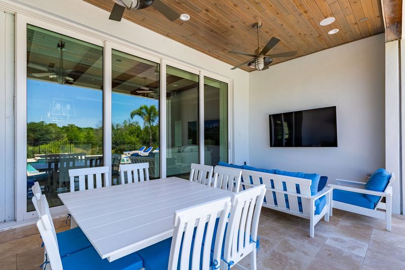 Enjoy the lanai featuring a 75-inch TV, table and sofa seating that can accommodate up to 10 guests