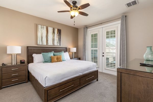 This beautiful master suite features a king size bed and balcony that has beautiful views