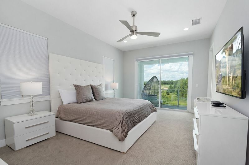 A beautiful master suite that has access to the second floor balcony