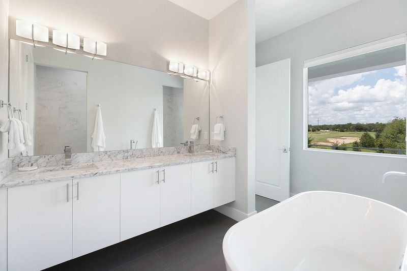 The ensuite bathroom with a garden tub and dual vanity