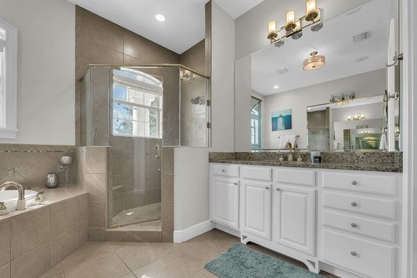 The master bathroom has a large walk-in closet, shower and his and her sinks