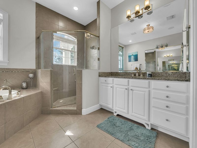 The master bathroom has a large walk-in closet, shower and his and her sinks