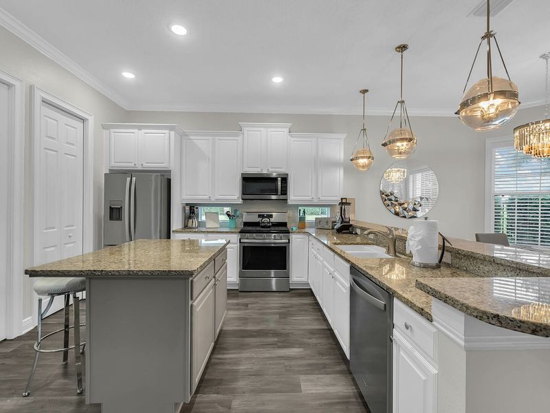 Large fully equipped kitchen with stainless steel appliances