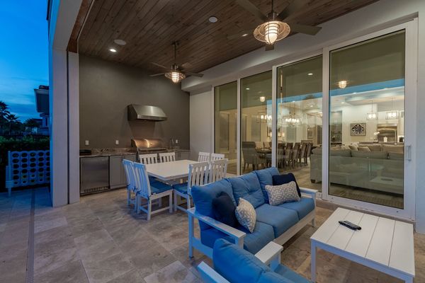 Day or night you can enjoy many amenities under the lanai, featuring a 75-inch TV, table and sofa seating that can accommodate up to 10 guests