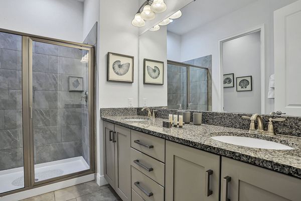 En suite bathroom with double vanity and walk-in shower