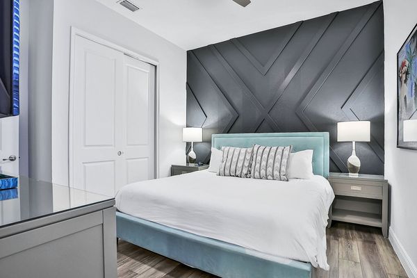 This bedroom features a king-sized bed and en suite bathroom