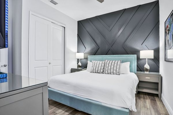 This bedroom features a king-sized bed and en suite bathroom