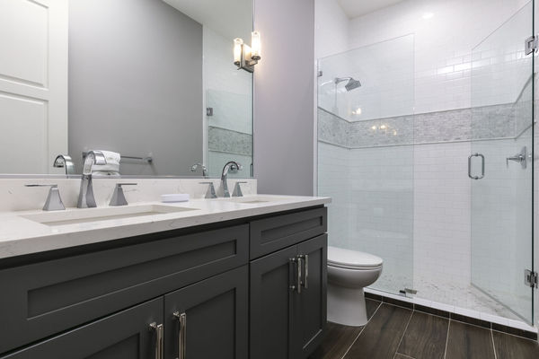 The ensuite bathroom with a dual vanity and walk-in shower
