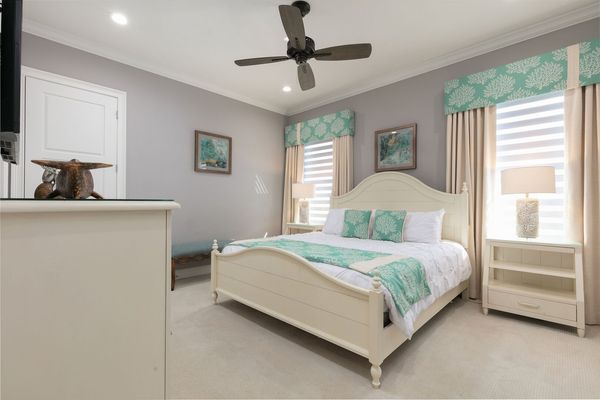 Sink into a king bed after a long day in this coastal-style suite