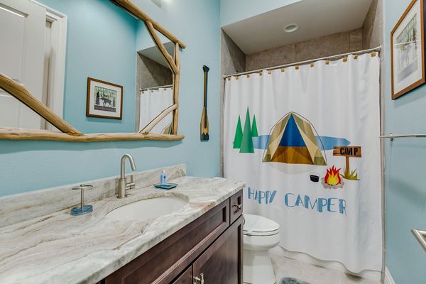 Themed bathroom with a shower and tub combo
