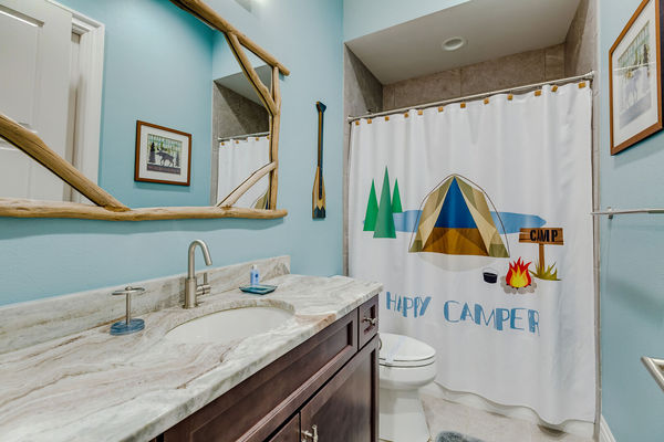 Themed bathroom with a shower and tub combo