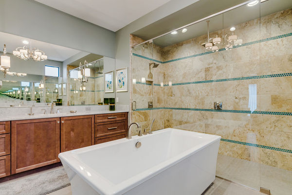 Featuring a garden tub and a walk in His and Her shower