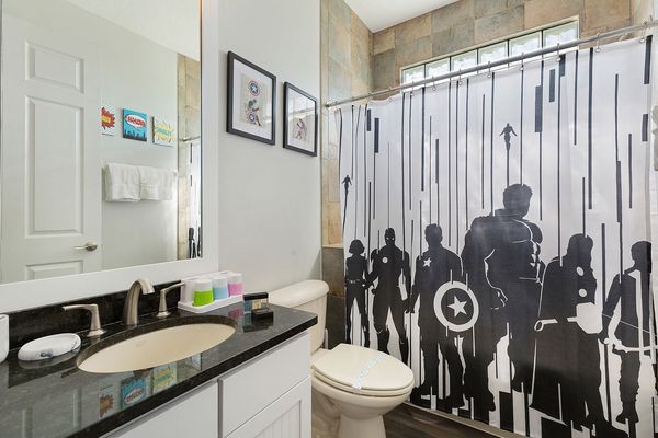 The ensuite bathroom features a shower/tub combination