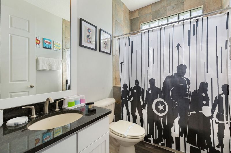 The ensuite bathroom features a shower/tub combination