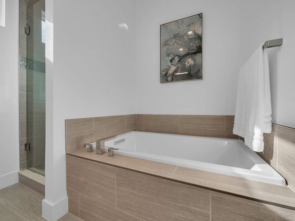 The ensuite bathroom has a large garden tub