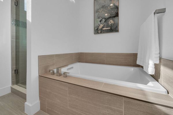 The ensuite bathroom has a large garden tub