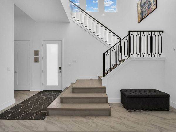 The stairs are located right by the entrance of the home