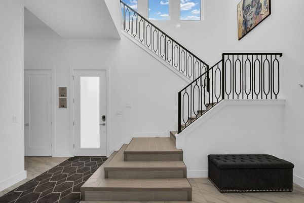 The stairs are located right by the entrance of the home