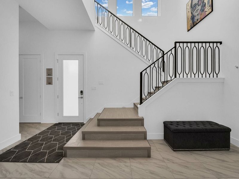The stairs are located right by the entrance of the home