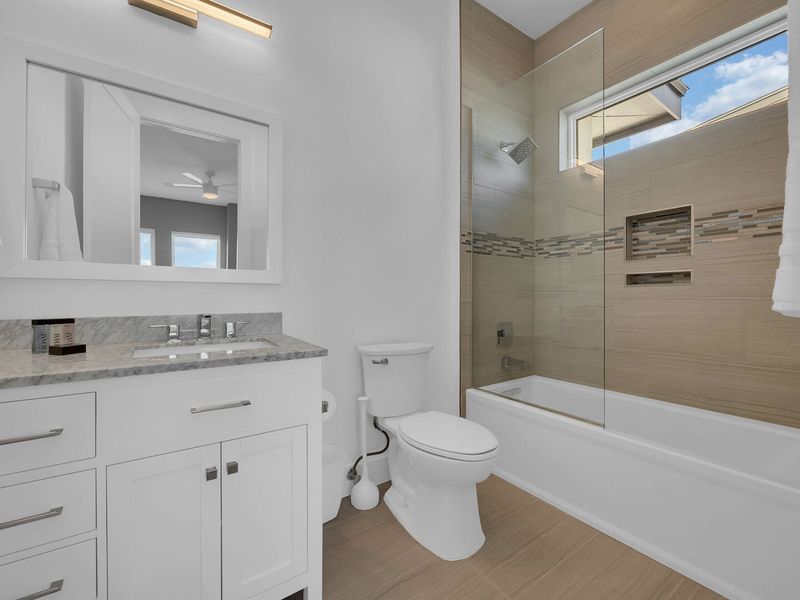 This bathroom has a combination shower and tub