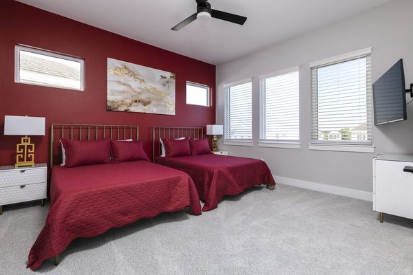 Sleep soundly in this bedroom with 2 full-size beds, plenty of natural lighting and a TV