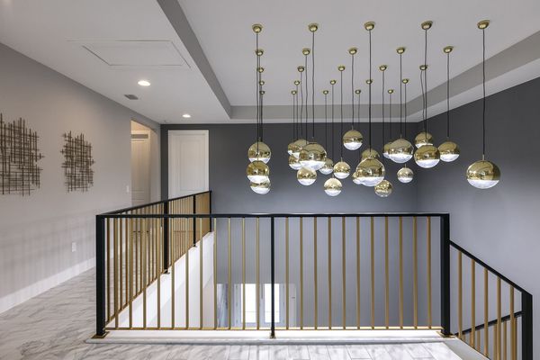 Gaze in awe at the custom light fixtures over the staircase