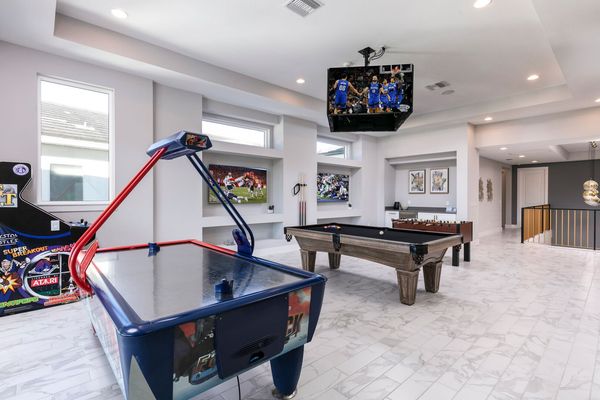 The loft is surrounded by 8 SMART TVs and a central jumbotron