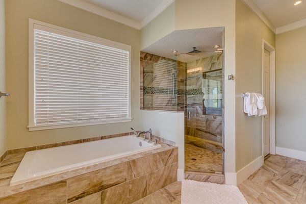 The ensuite bathroom has a garden tub and a walk-in shower