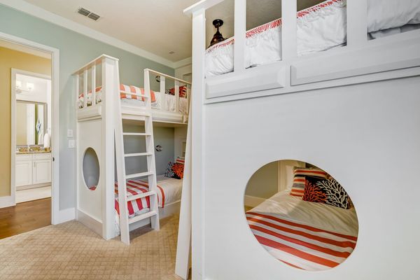 Fun kids bedroom with two sets of twin over twin bunk beds