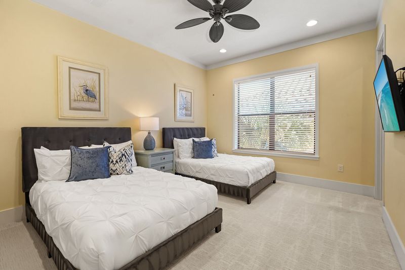 This bedroom has 2 full beds and a TV