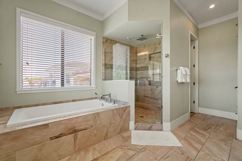 The ensuite bathroom has a garden tub and a walk-in shower