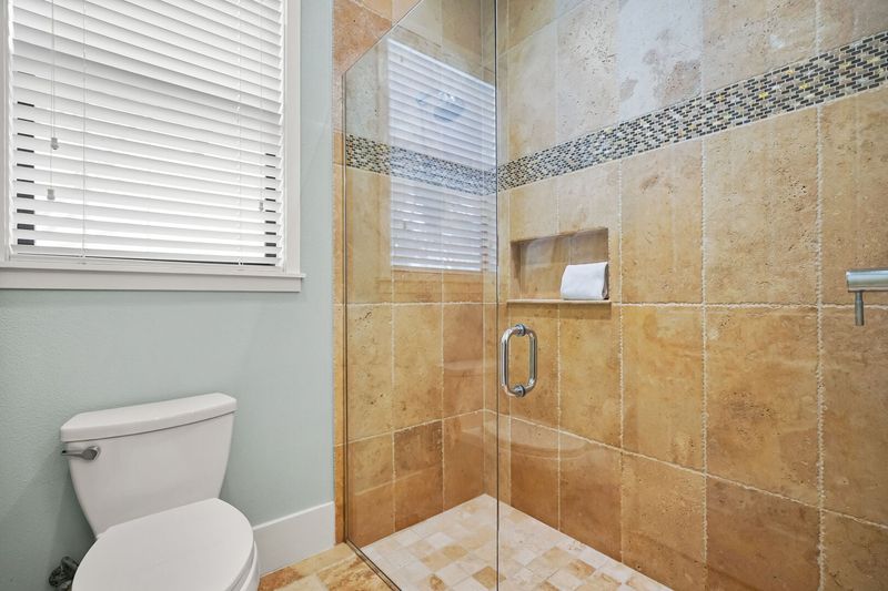 Jack and Jill bathroom with walk in shower and toilet