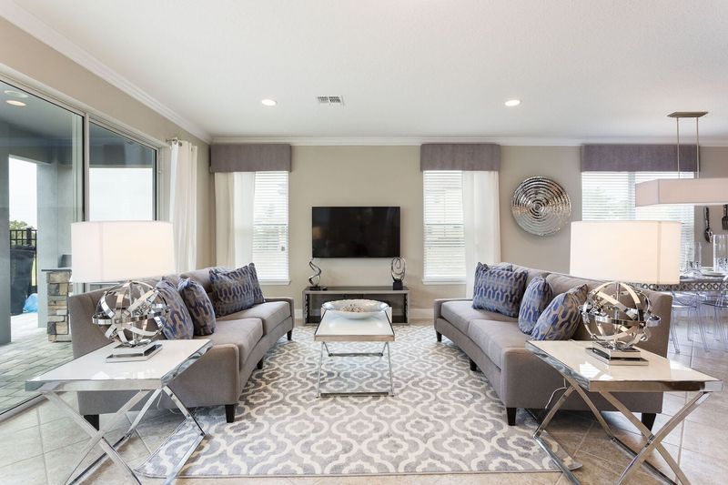 The living area features a 60-inch SMART TV