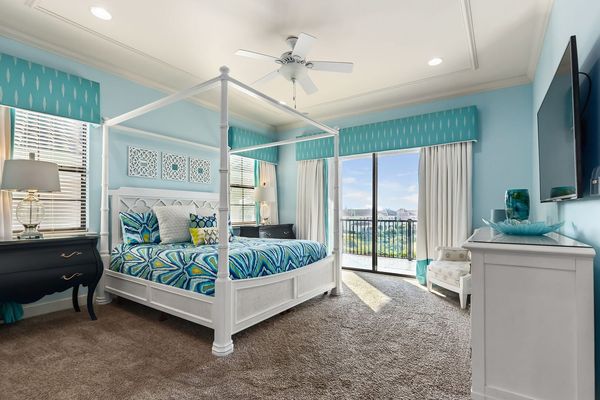 This bright second floor bedroom has access to the balcony and will help you truly vacation