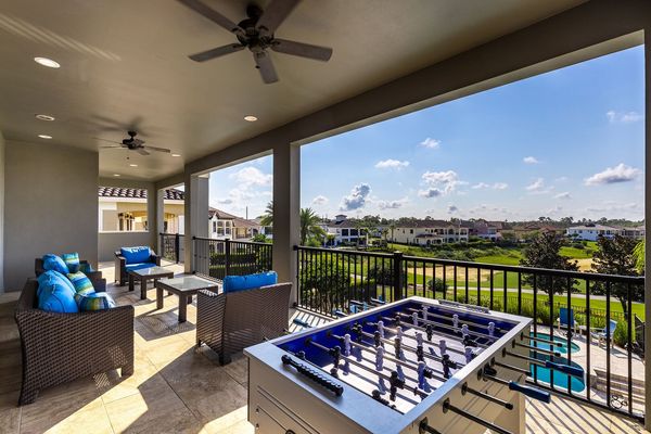 The balcony has an outdoor foosball table and luxury seating