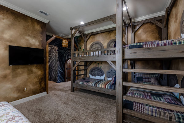 Featuring 2 twin over twin bunk beds, a daybed, and an ensuite bathroom