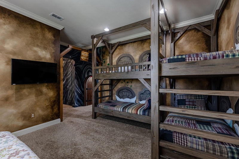Featuring 2 twin over twin bunk beds, a daybed, and an ensuite bathroom